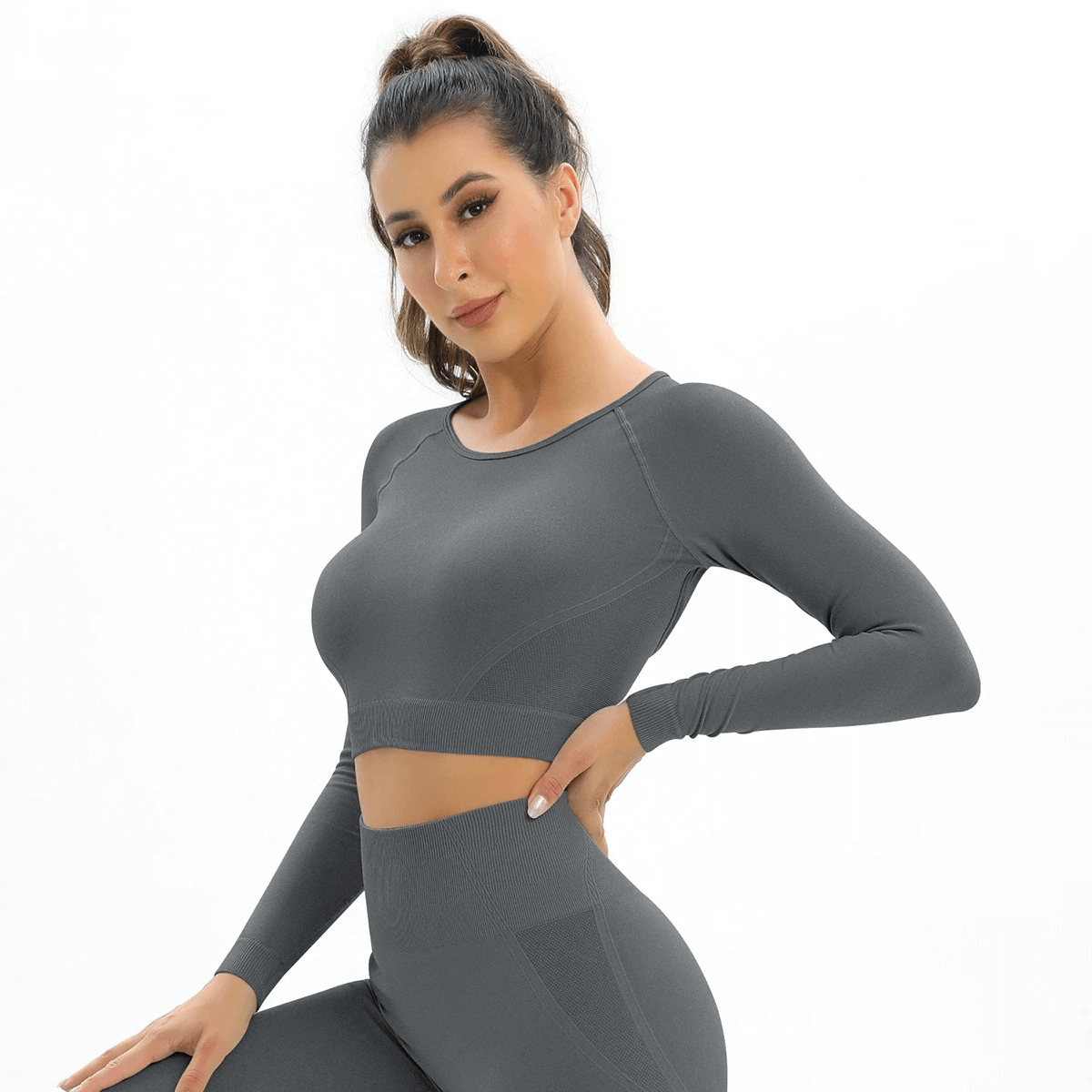 Model wearing Seamless Women's Open Back Long Sleeve Yoga Top in gray, ideal for gym and sports, stylish and breathable design.